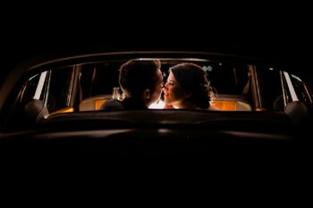 Couple kissing in getaway vehicle at Bakers Ranch wedding venue Parrish FL by Ying Multimedia