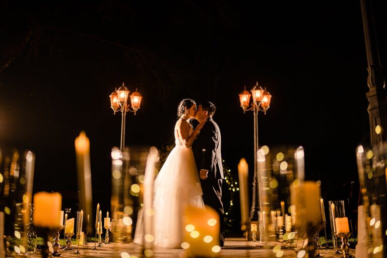 Erika and Jorge kissing at Infinity Forest in the dark surrounded by candles at Bakers Ranch by Ying Multimedia