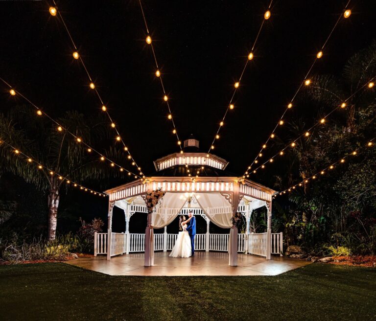 Bride and groom dancing under string lights at the gazebo, Pavilion at Mixon Farms wedding photographer