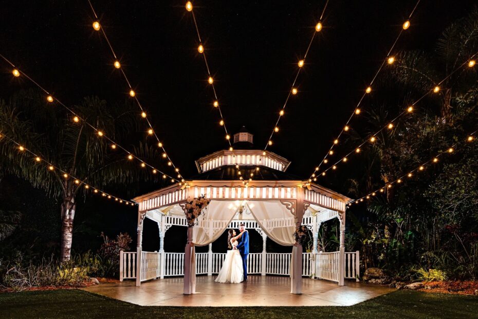 Bride and groom dancing under string lights at the gazebo, Pavilion at Mixon Farms wedding photographer